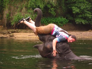 Crystal bathing 5 year old elephant, Johnny. Elephants World, Kanchanaburi, Thailand.