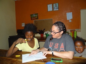 Helping the children with their homework at OZ Kids International Orphanage. 